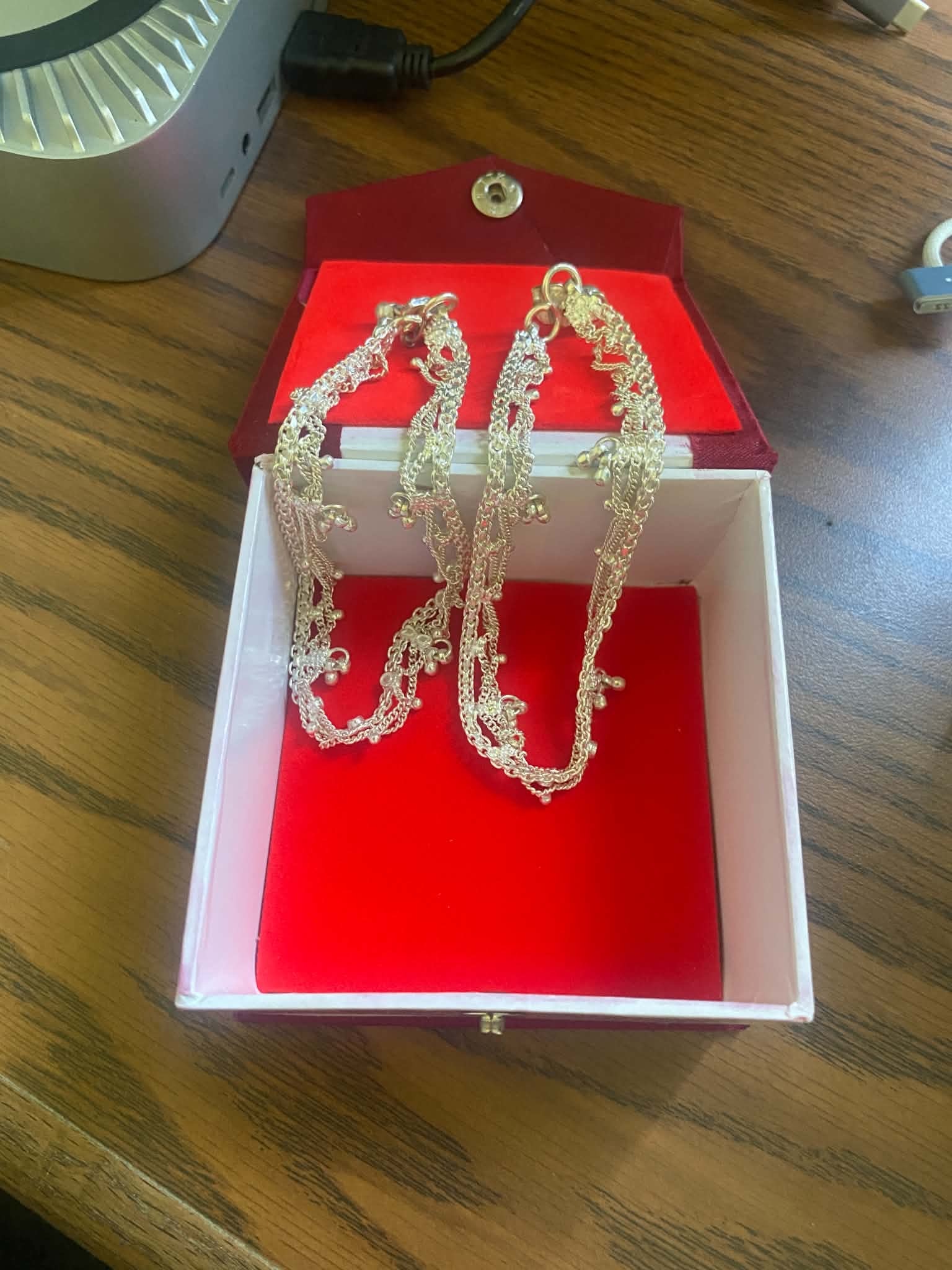 Gold jewelry waiting in a red presentation box